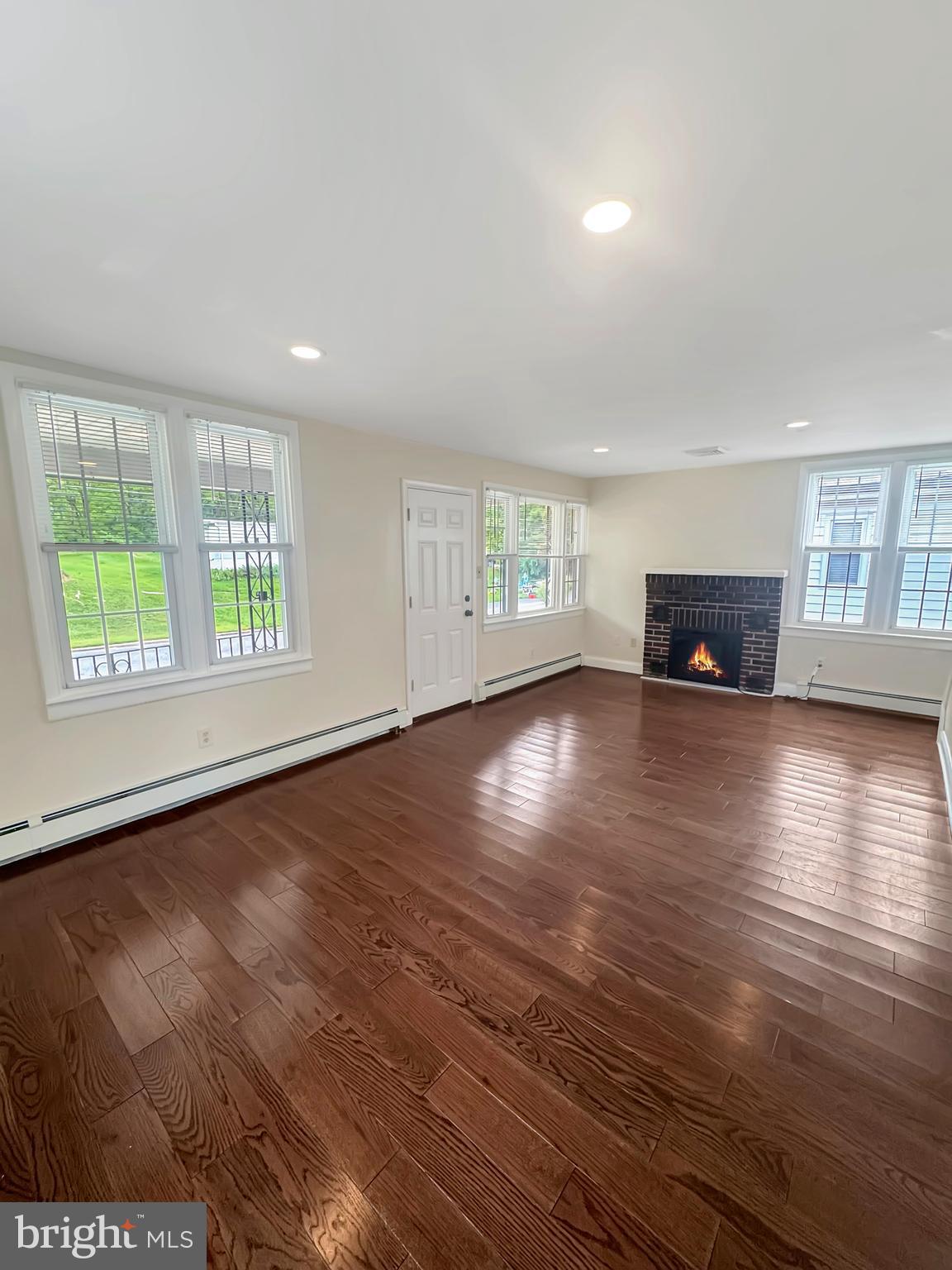 1027 Riverside Drive Pottstown, PA 19465 - Photo 10 of 24 an empty room with windows wooden floor and windows
