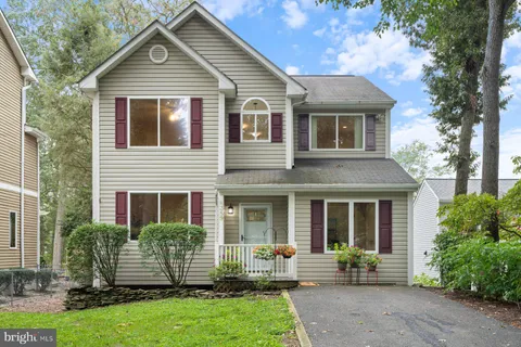 a front view of a house with garden and porch