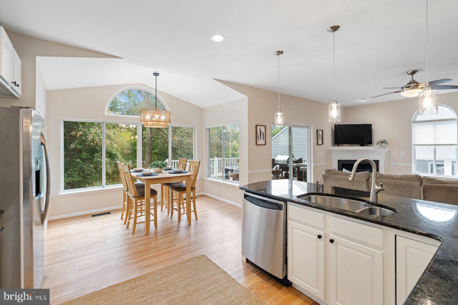 359 Valley Stream Road Severna Park, MD 21146 - Photo 15 of 55 a dining room with stainless steel appliances granite countertop a kitchen island hardwood floor and a sink