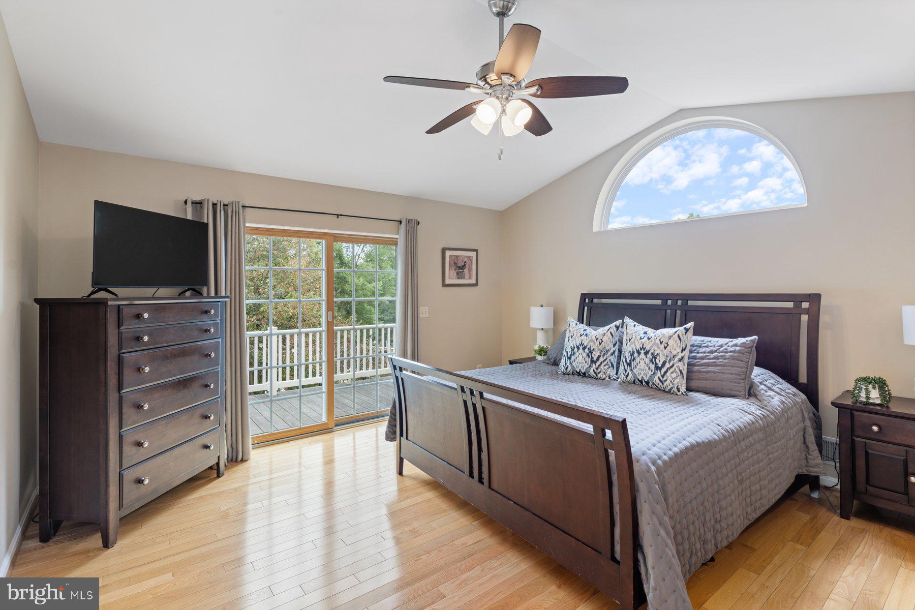 359 Valley Stream Road Severna Park, MD 21146 - Photo 19 of 55 a living room with a bed furniture flat screen tv and a large window