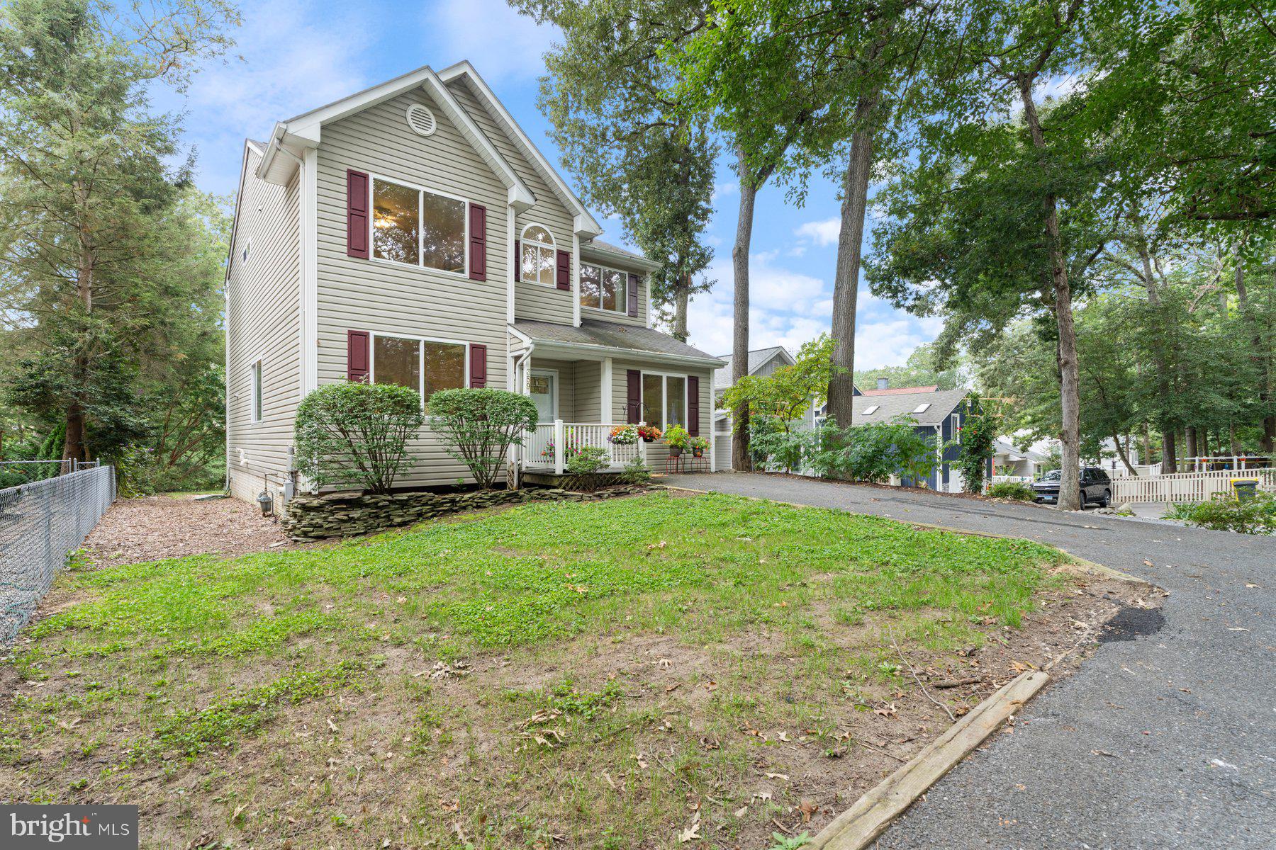 359 Valley Stream Road Severna Park, MD 21146 - Photo 2 of 55 a front view of a house with a garden and trees
