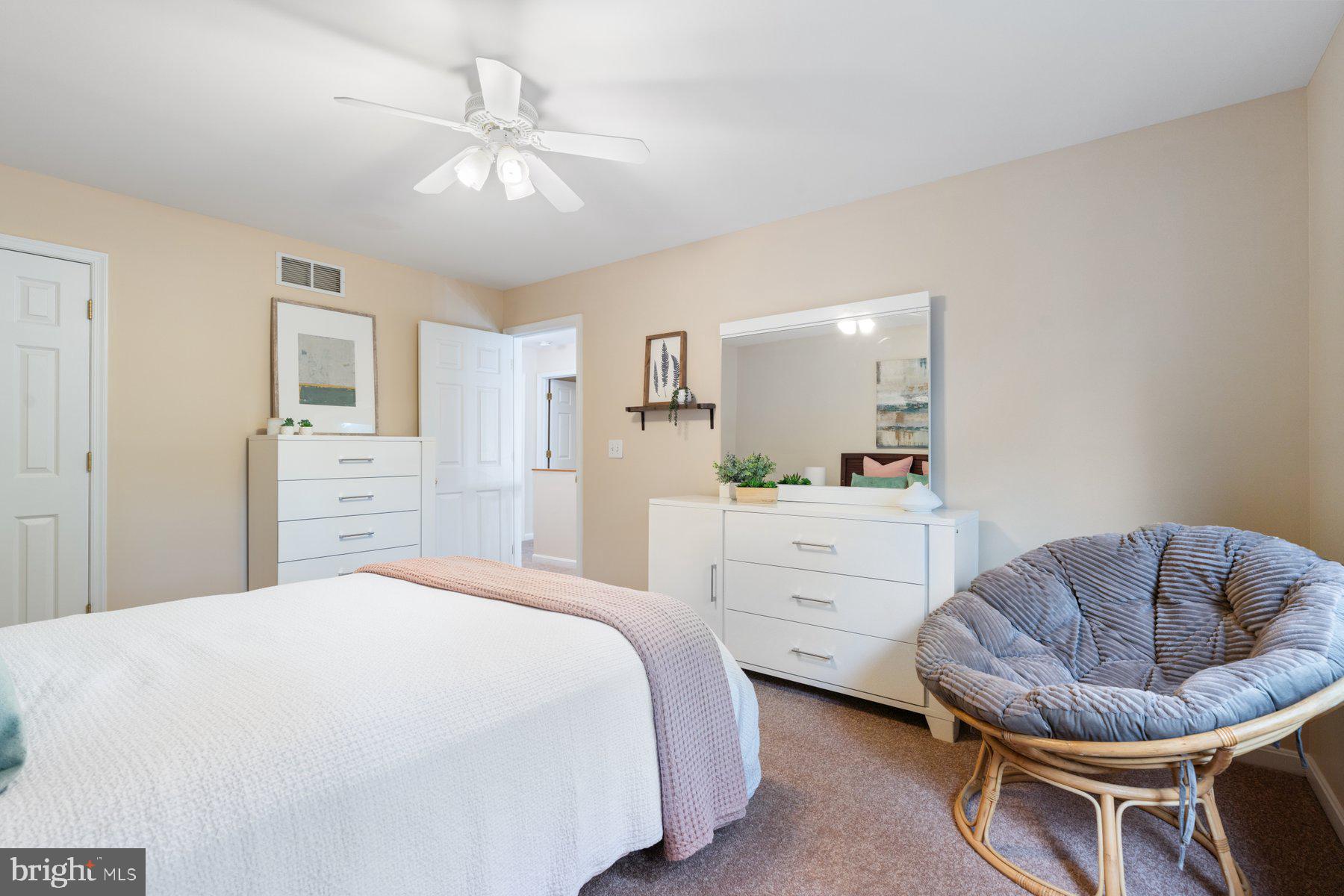 359 Valley Stream Road Severna Park, MD 21146 - Photo 28 of 55 a spacious bedroom with a bed a couch and a chandelier