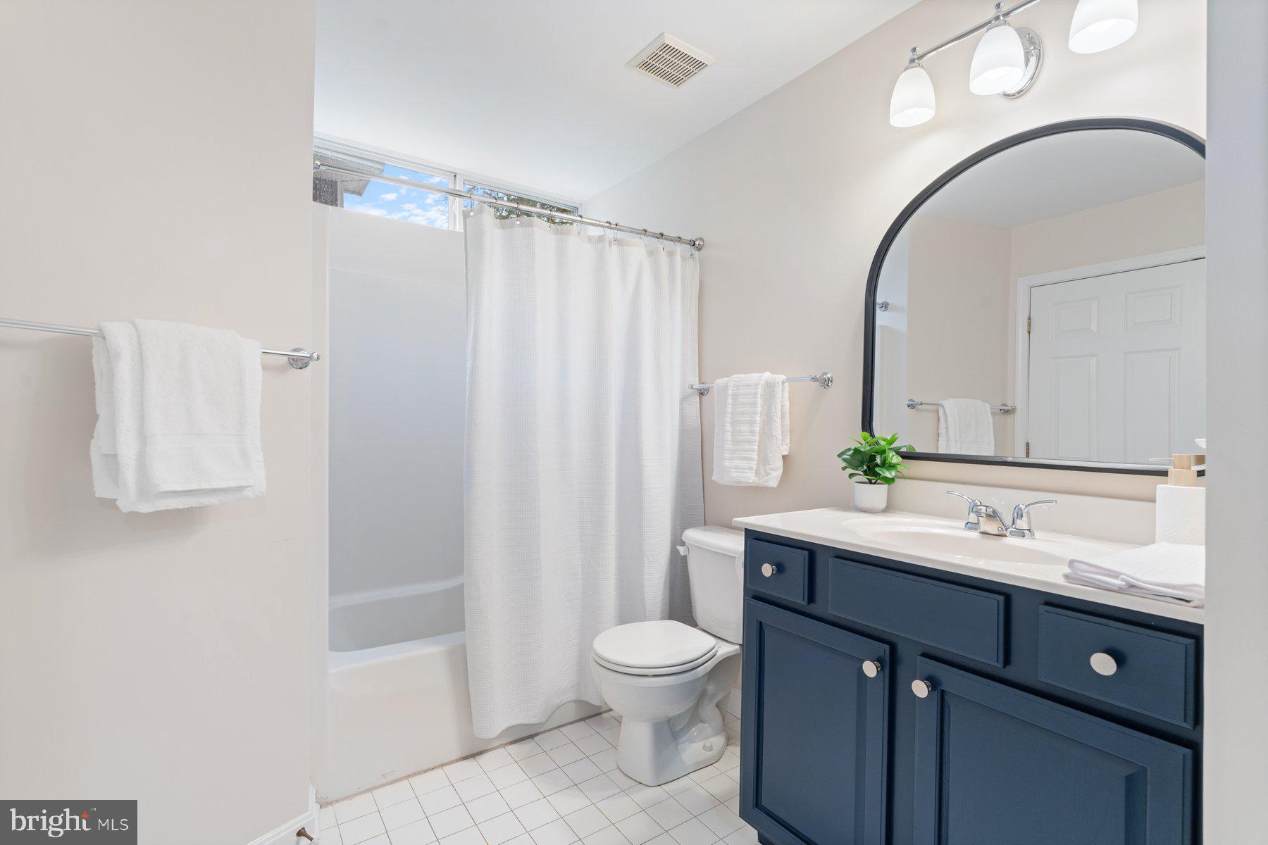 359 Valley Stream Road Severna Park, MD 21146 - Photo 29 of 55 a spacious bathroom with a granite countertop sink a toilet and a mirror