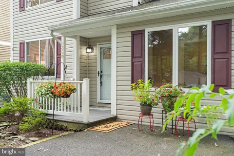 a front view of a house with a yard and trees