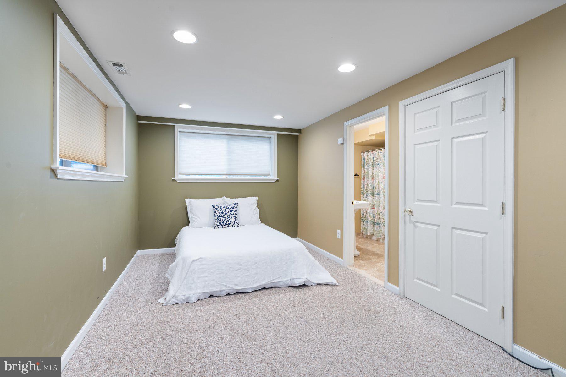359 Valley Stream Road Severna Park, MD 21146 - Photo 33 of 55 a bedroom with a large bed and a chandelier