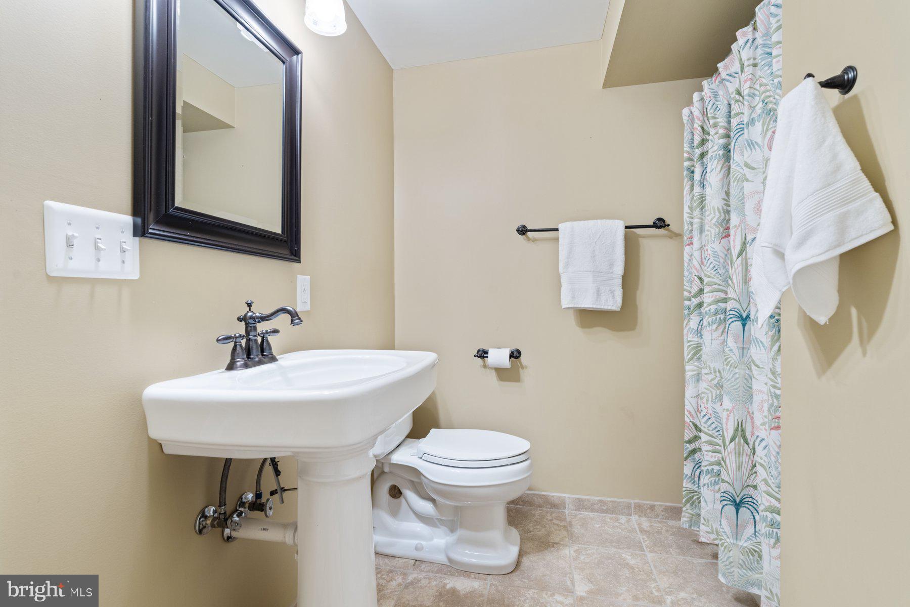359 Valley Stream Road Severna Park, MD 21146 - Photo 34 of 55 a bathroom with a sink toilet and mirror