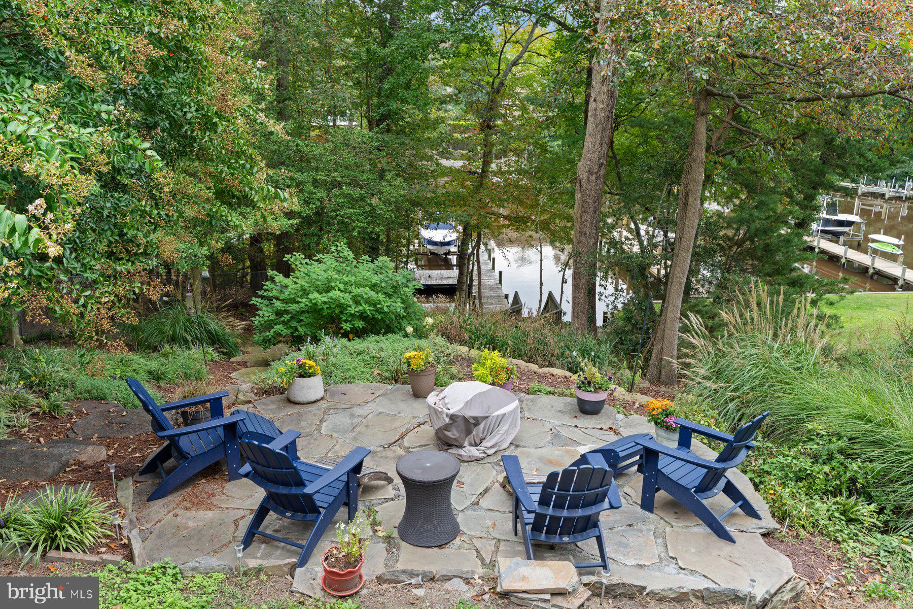 359 Valley Stream Road Severna Park, MD 21146 - Photo 37 of 55 a view of a patio with table and chairs and potted plants