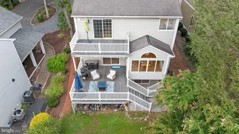aerial view of a house with a big yard and large trees