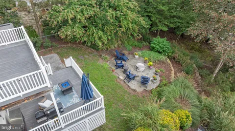 a view of a yard with plants and wooden fence