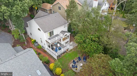 a swimming pool with outdoor seating and plants