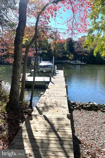 a view of a pathway with a chair and table in the patio