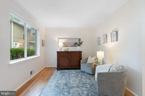 a view of a livingroom with wooden floor and a window