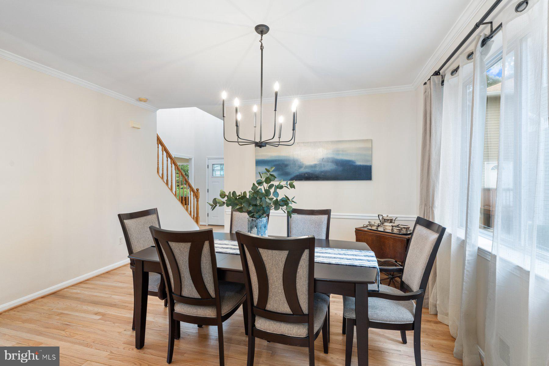 359 Valley Stream Road Severna Park, MD 21146 - Photo 10 of 55 a view of a dining room with furniture a chandelier and wooden floor