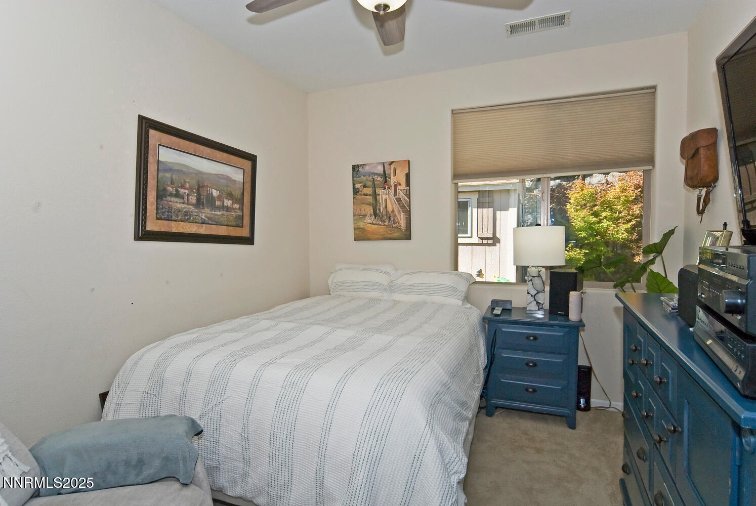 4823 Tree Swallow Lane Sparks, NV 89436 - Photo 12 of 12 a bedroom with a bed and a flat tv screen on dresser