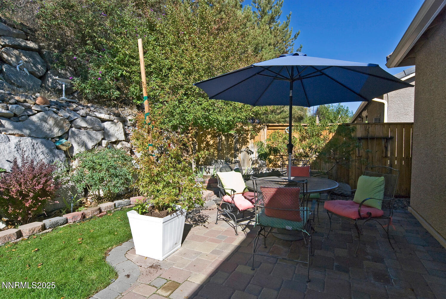 4823 Tree Swallow Lane Sparks, NV 89436 - Photo 2 of 12 a view of a table and chairs under an umbrella in backyard