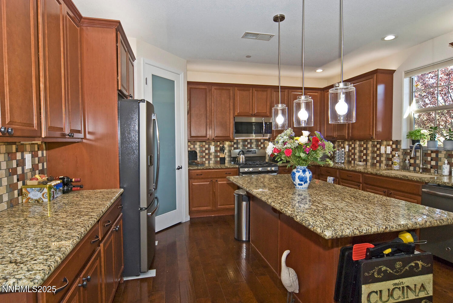 4823 Tree Swallow Lane Sparks, NV 89436 - Photo 4 of 12 a kitchen with stainless steel appliances granite countertop a sink a stove and a wooden floors