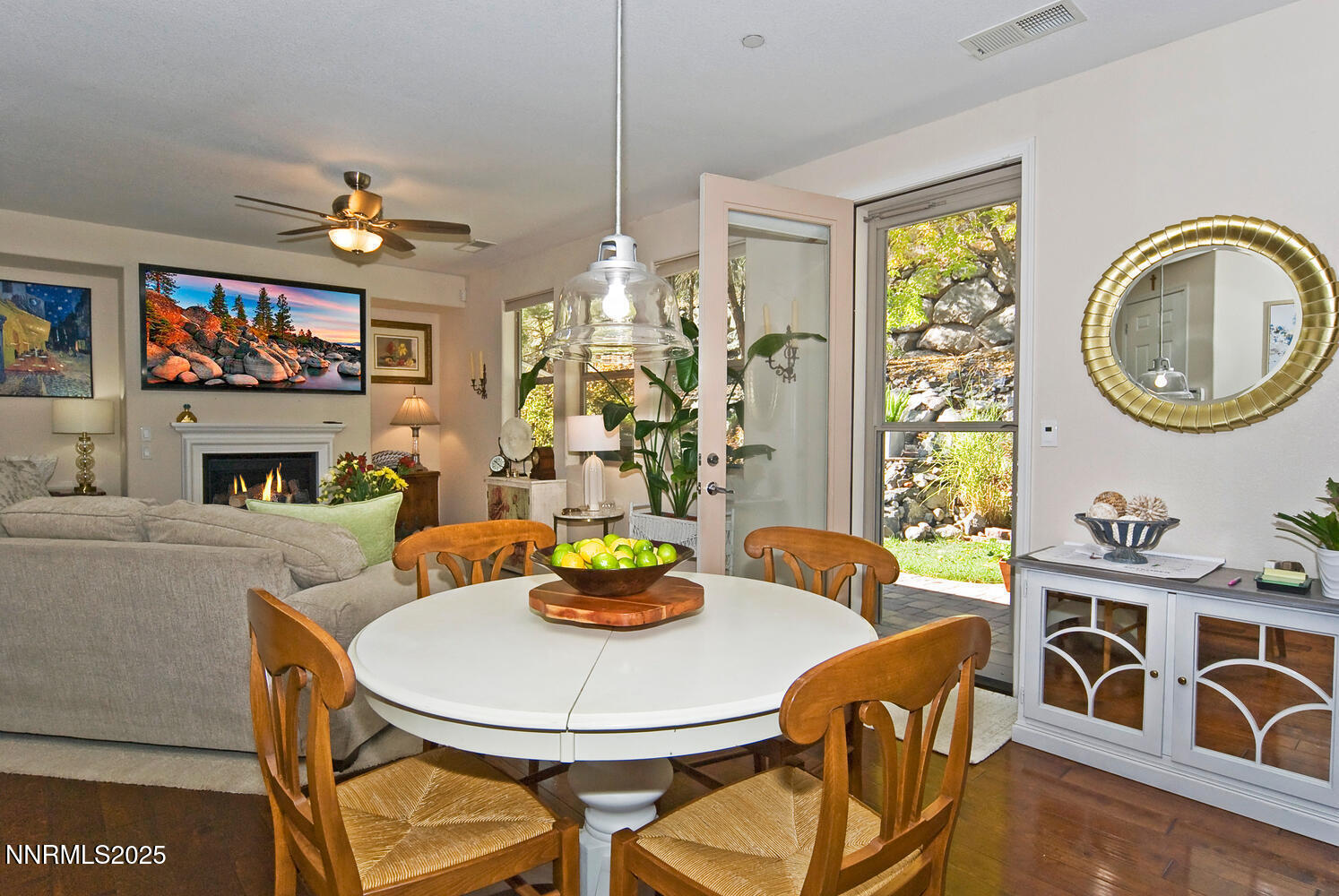 4823 Tree Swallow Lane Sparks, NV 89436 - Photo 5 of 12 a dining room with furniture a fireplace and open kitchen view