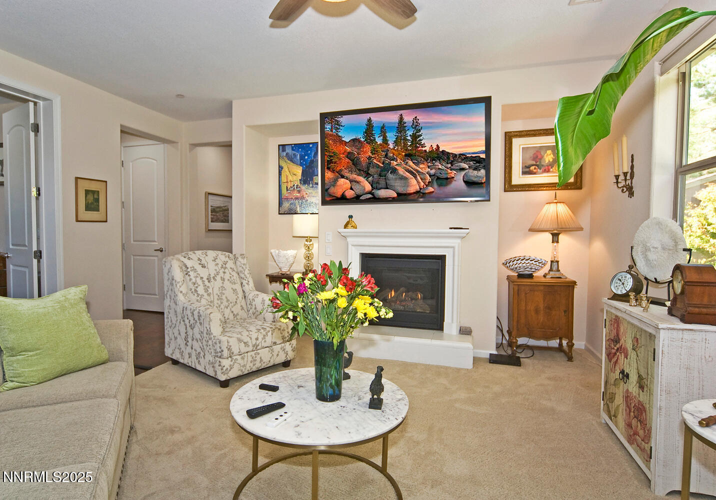 4823 Tree Swallow Lane Sparks, NV 89436 - Photo 7 of 12 a living room with furniture potted plant and a fireplace