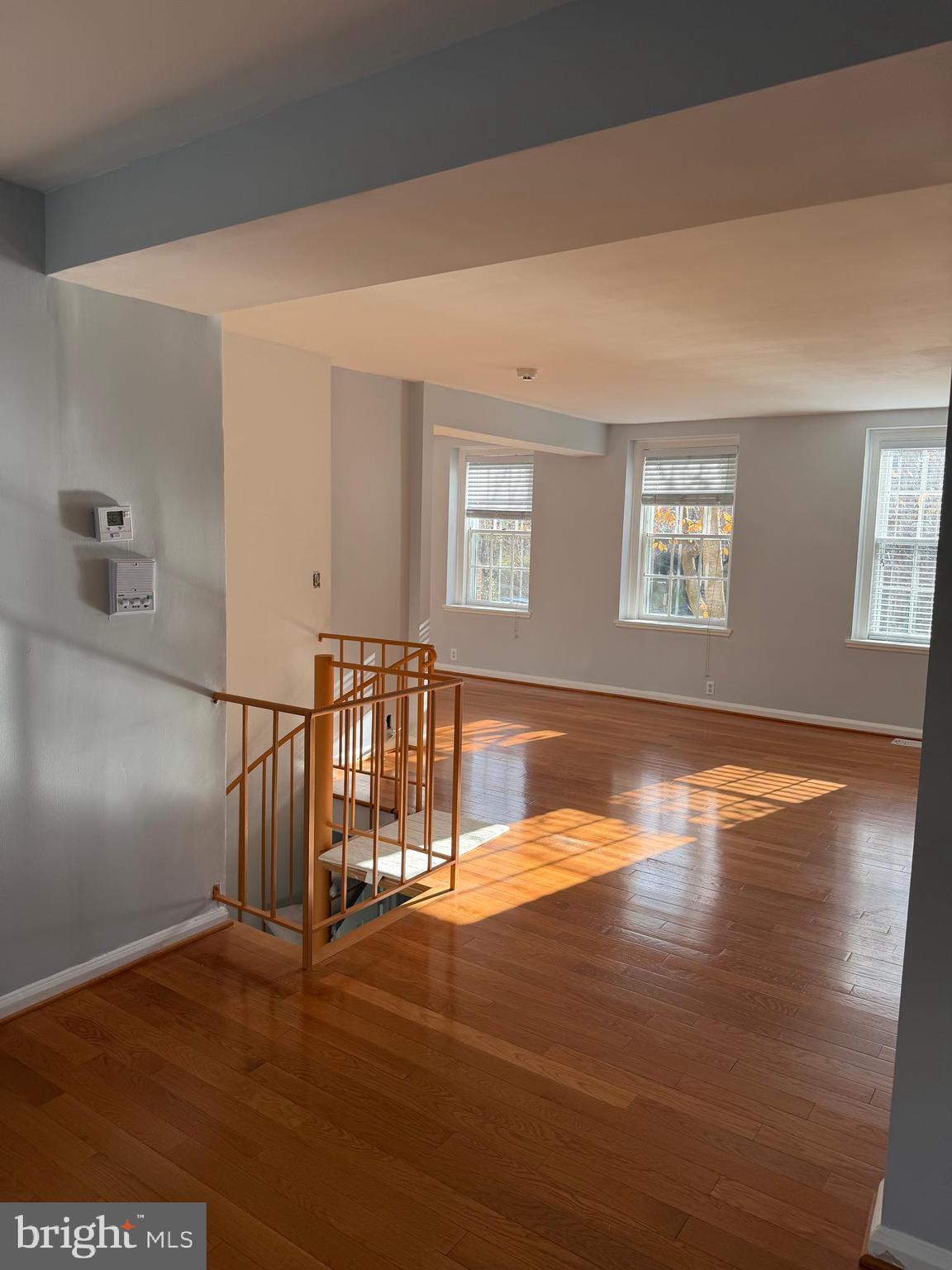 3881 Porter Street Northwest, Unit A295 Washington, DC 20016 - Photo 14 of 15 a view of an empty room with window and wooden floor
