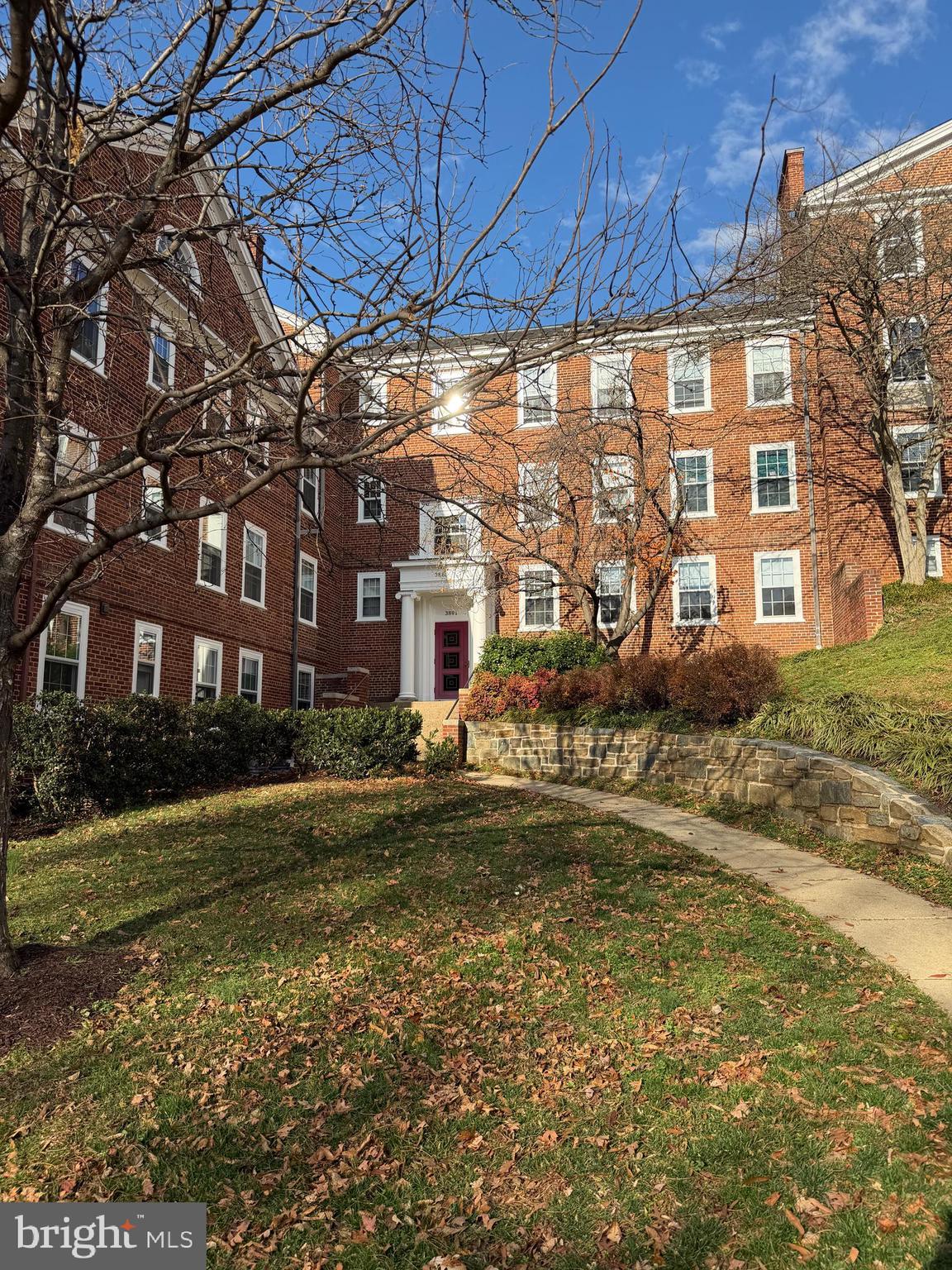 3881 Porter Street Northwest, Unit A295 Washington, DC 20016 - Photo 2 of 15 a front view of a house with a yard