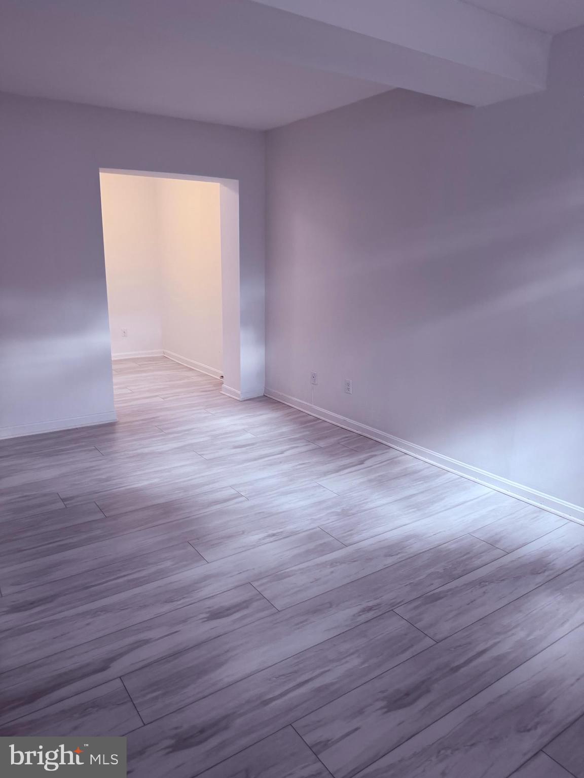 3881 Porter Street Northwest, Unit A295 Washington, DC 20016 - Photo 4 of 15 wooden floor in an empty room
