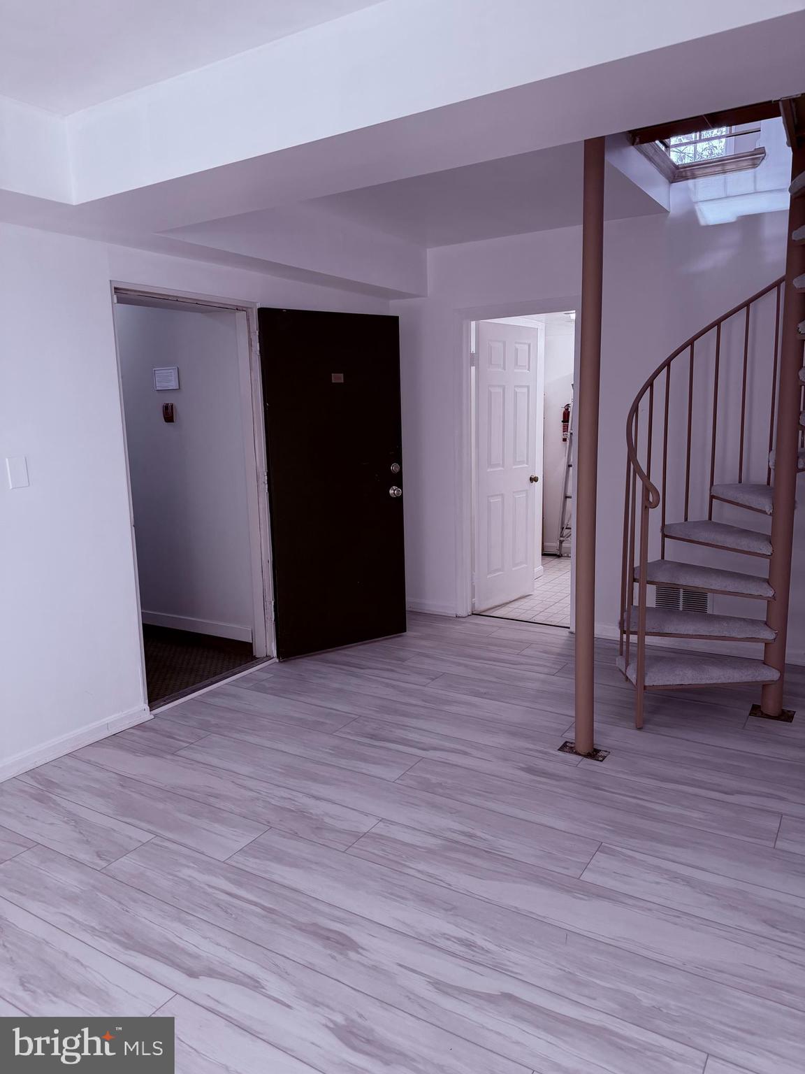 3881 Porter Street Northwest, Unit A295 Washington, DC 20016 - Photo 5 of 15 a view of a hallway with wooden floor and stairs