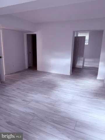 a view of an empty room and wooden floor