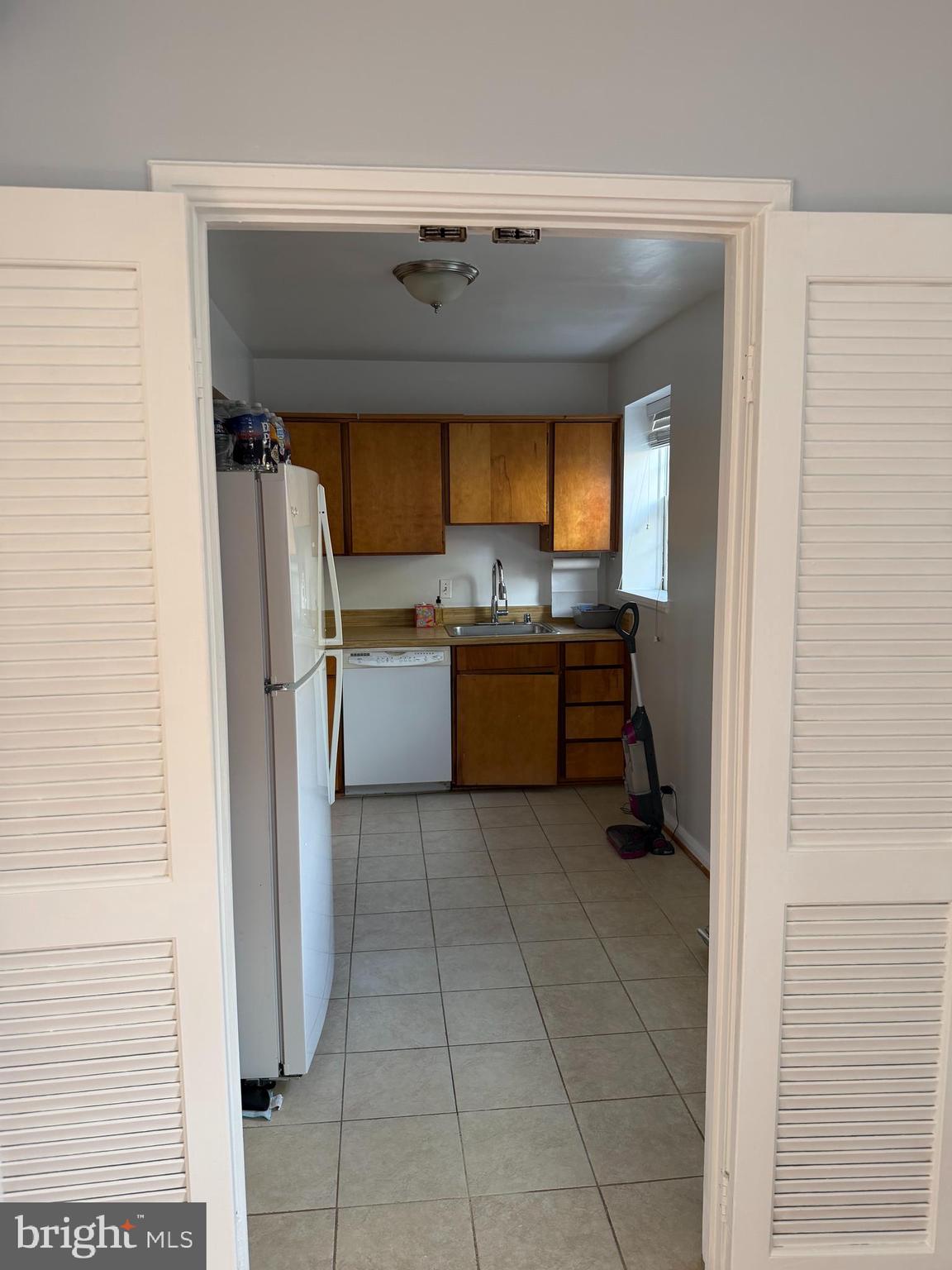 3881 Porter Street Northwest, Unit A295 Washington, DC 20016 - Photo 10 of 15 a kitchen with a refrigerator and a stove