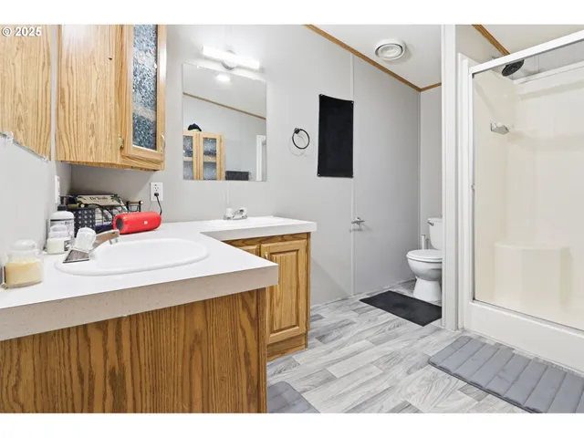 a bathroom with a sink toilet and shower