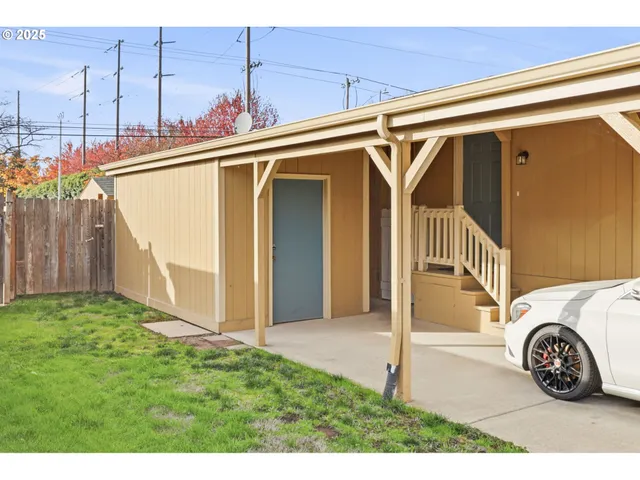 a view of a house with a wooden deck