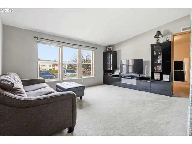 a living room with furniture and large windows