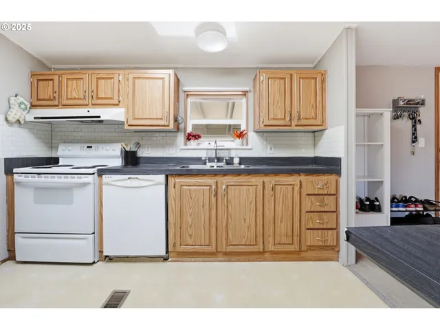 a kitchen with a sink stove and cabinets
