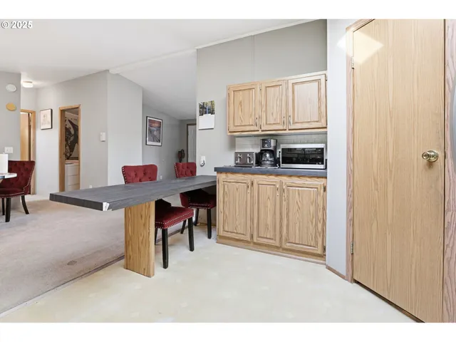 a living room with furniture a window and kitchen view