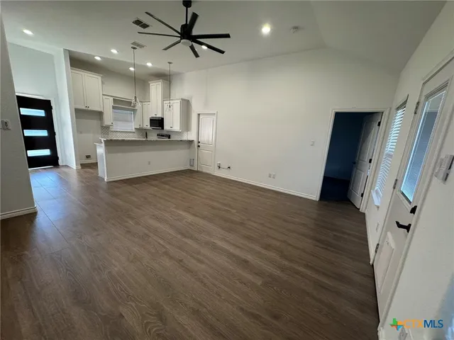 a view of kitchen with wooden floor and electronic appliances