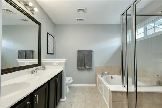 a bathroom with a tub sink and mirror
