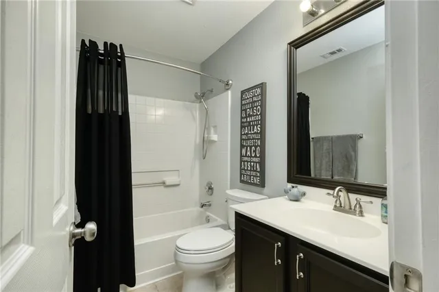 a bathroom with a double vanity sink toilet and shower