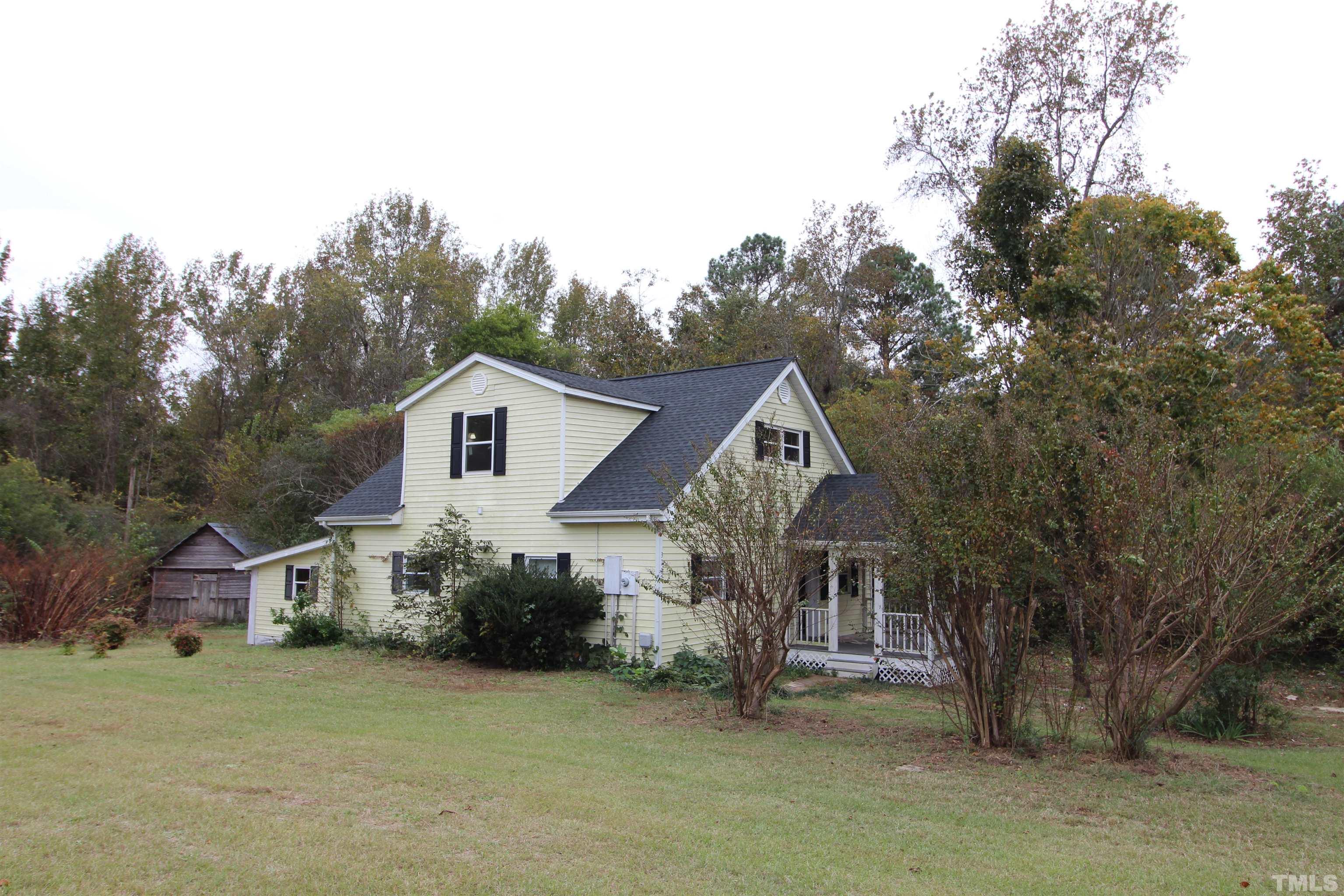 3202 Old Stage Road North Coats, NC 27521 - Photo 1 of 20 a view of a house with a big yard plants and large trees