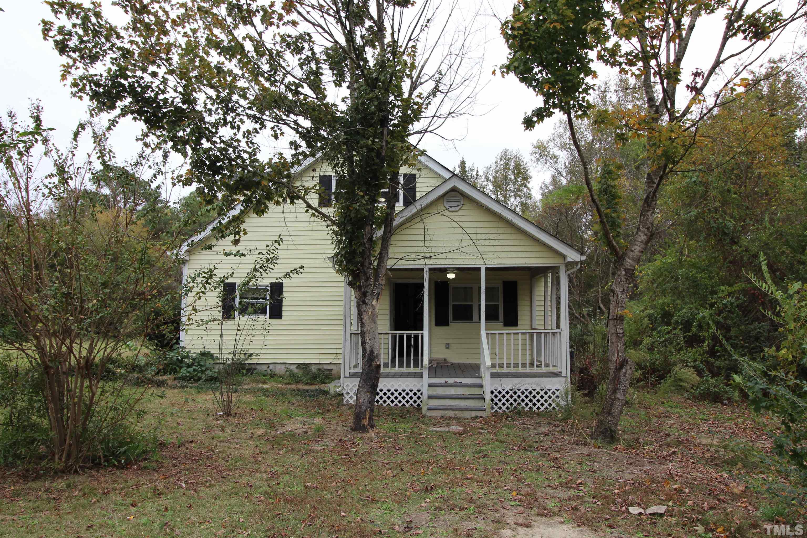 3202 Old Stage Road North Coats, NC 27521 - Photo 2 of 20 a house with trees in front of it