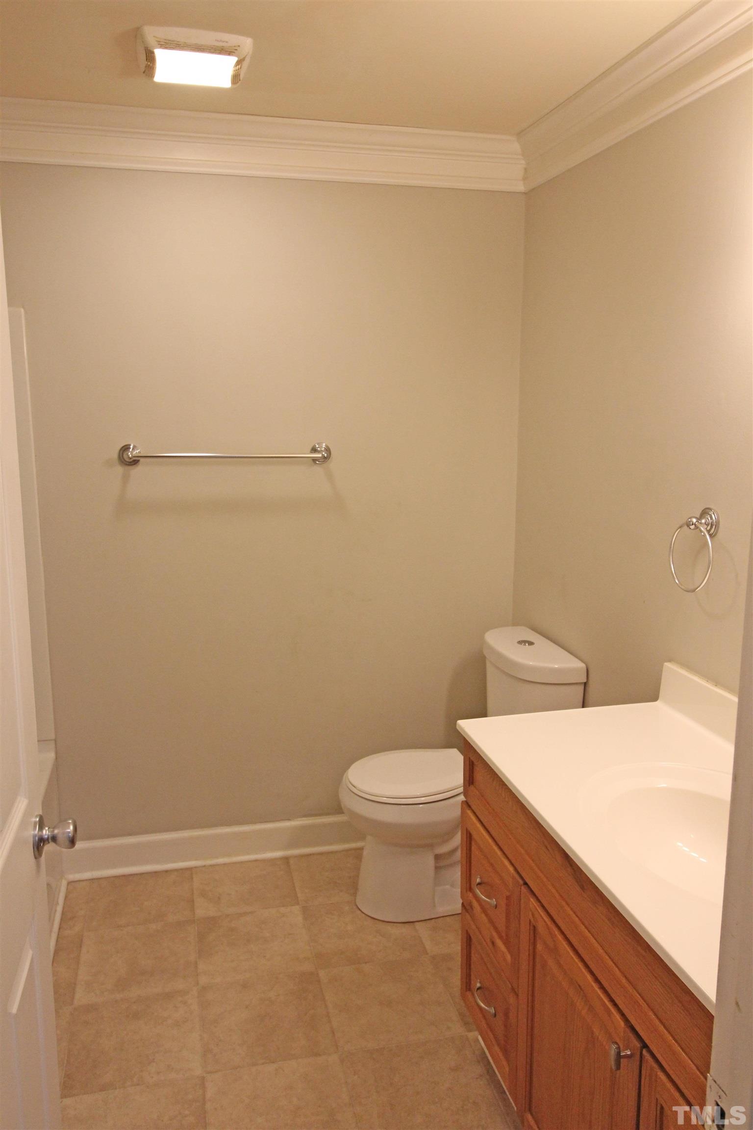 3202 Old Stage Road North Coats, NC 27521 - Photo 11 of 20 a bathroom with a sink a toilet and vanity