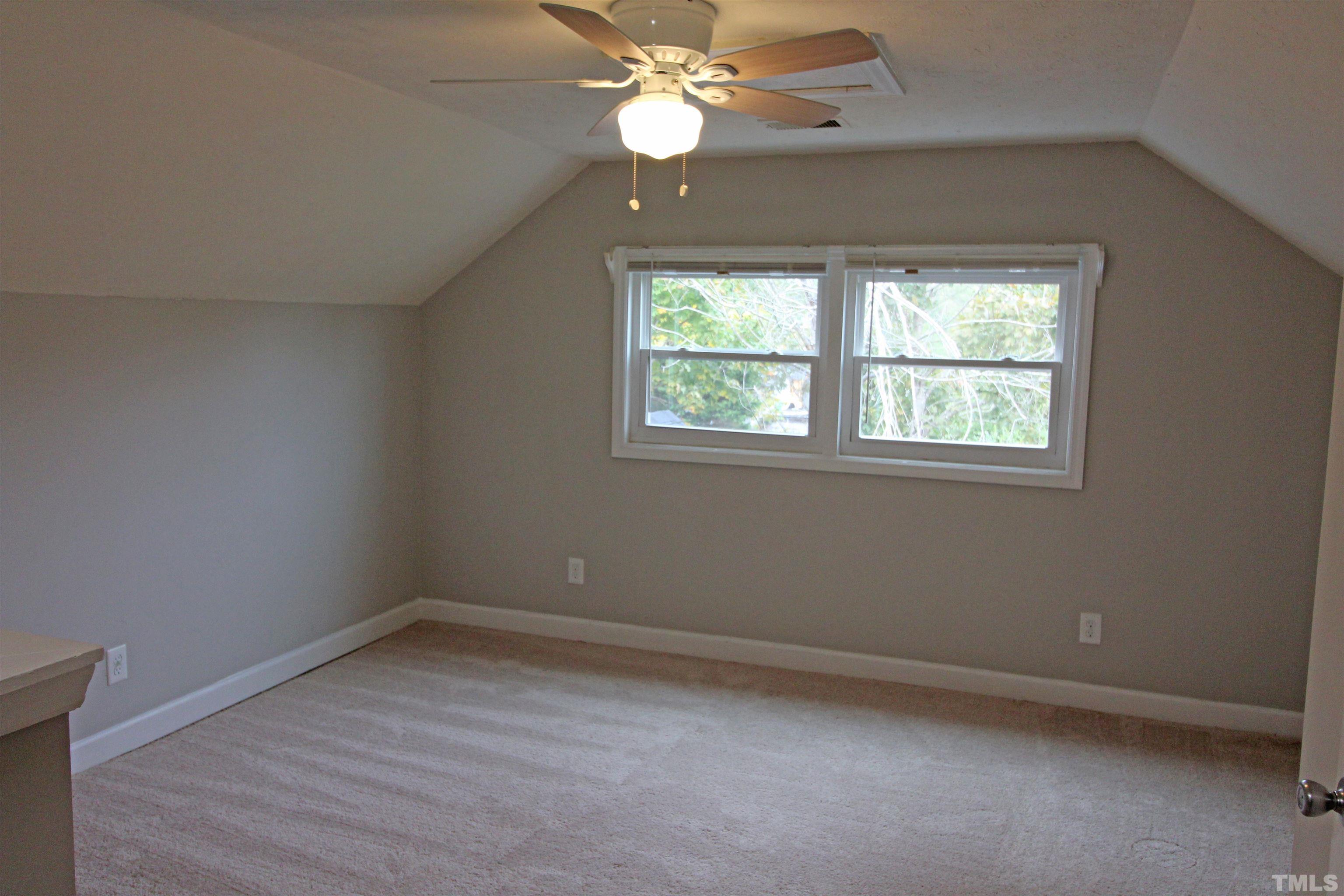 3202 Old Stage Road North Coats, NC 27521 - Photo 17 of 20 an empty room with a window and a fan