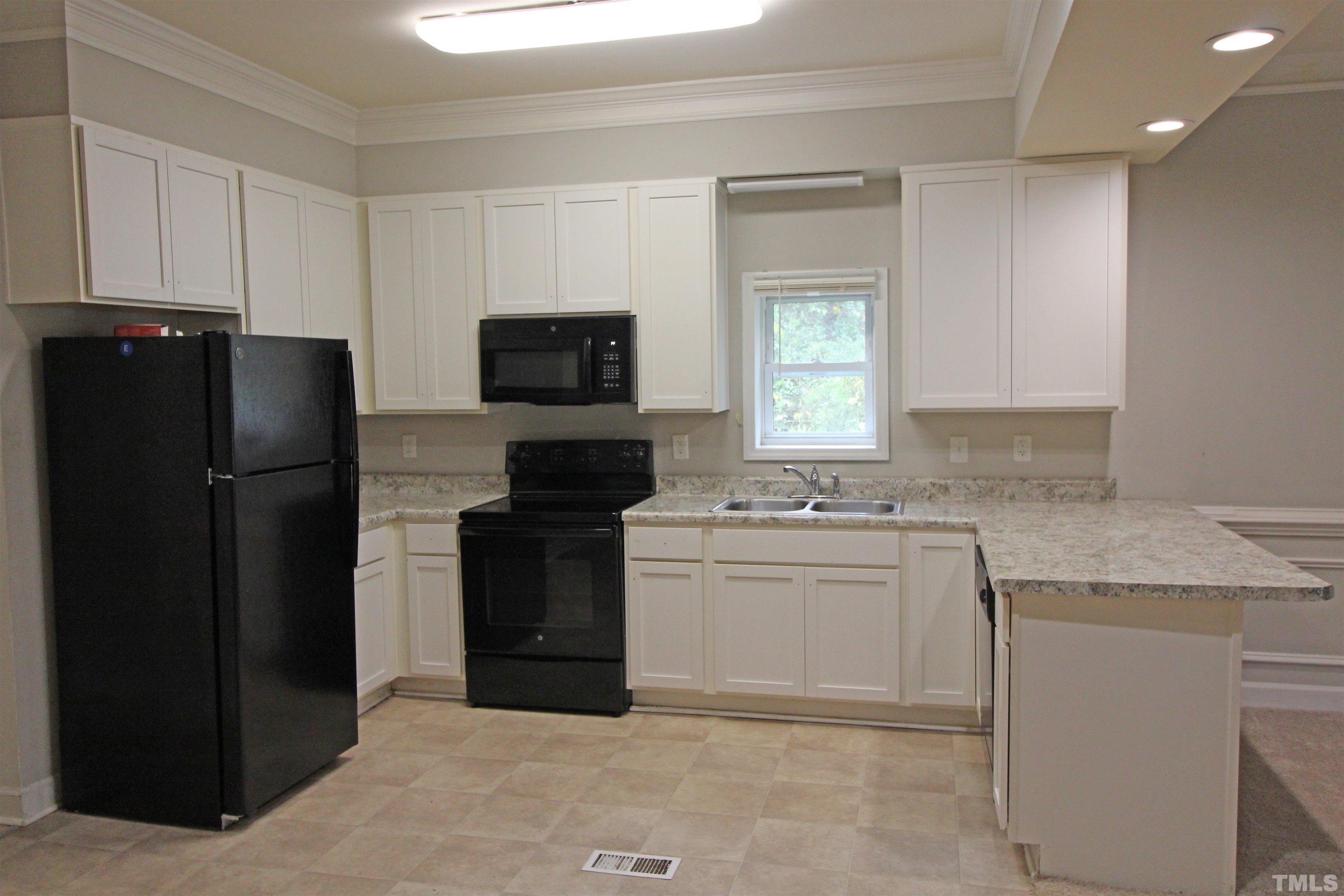 3202 Old Stage Road North Coats, NC 27521 - Photo 5 of 20 a kitchen with a sink stove and refrigerator