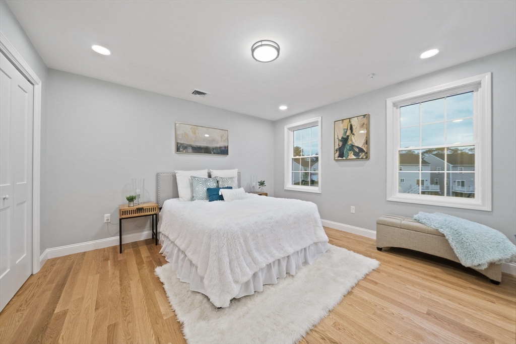 8 Simmonds Boulevard, Unit 8 Randolph, MA 02368 - Photo 16 of 28 a spacious bedroom with a bed and wooden floor
