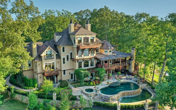 an aerial view of a house with swimming pool and garden