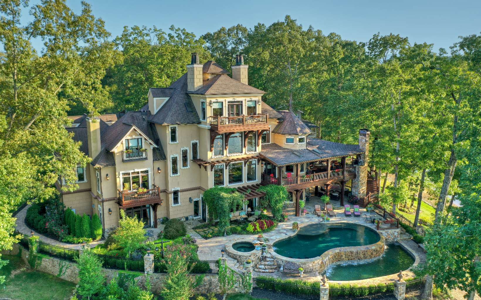 an aerial view of a house with swimming pool and garden