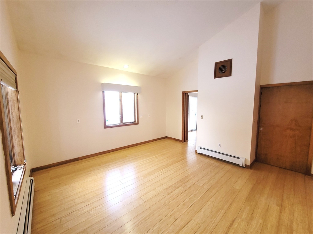 46 Long Hill Road, Unit RIGHT Groton, MA 01450 - Photo 13 of 30 an empty room with wooden floor and windows