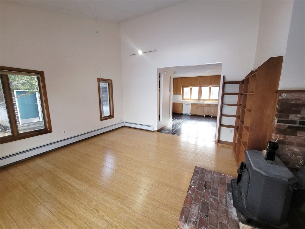 46 Long Hill Road, Unit RIGHT Groton, MA 01450 - Photo 17 of 30 a view of empty room with wooden floor and fan