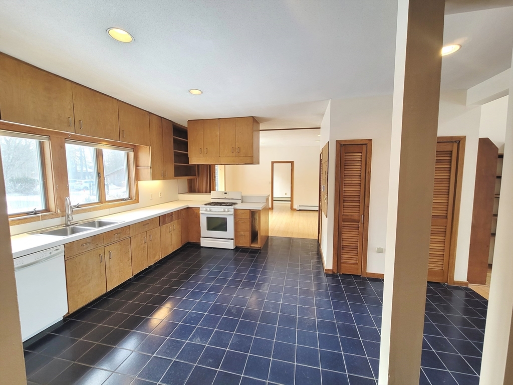 46 Long Hill Road, Unit RIGHT Groton, MA 01450 - Photo 21 of 30 a large white kitchen with a stove a refrigerator and a sink