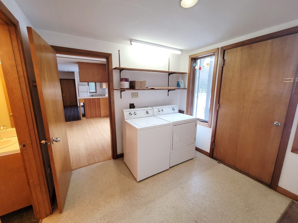 46 Long Hill Road, Unit RIGHT Groton, MA 01450 - Photo 26 of 30 a utility room with cabinets washer and dryer