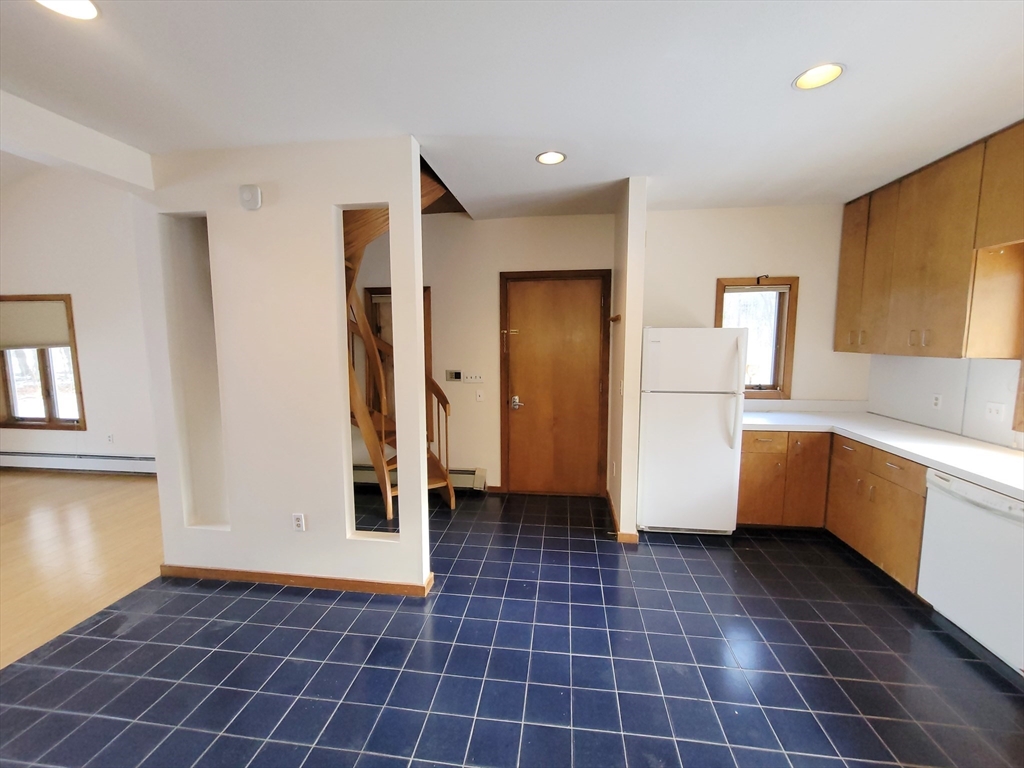 46 Long Hill Road, Unit RIGHT Groton, MA 01450 - Photo 3 of 30 a kitchen with a sink a refrigerator and cabinets