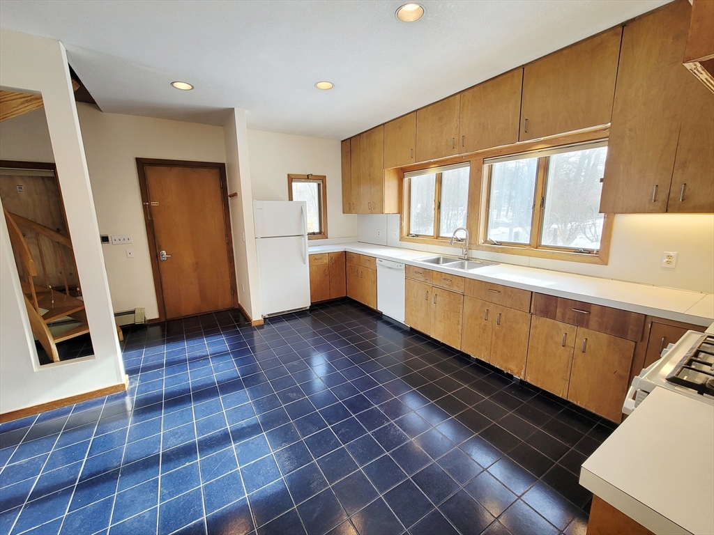 46 Long Hill Road, Unit RIGHT Groton, MA 01450 - Photo 4 of 30 a large kitchen with a wooden floor and a window